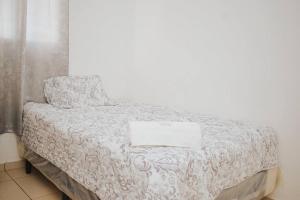 a bed with a white comforter with a laptop on it at Moderna casa amueblada en residencial privada in San Miguel +22 photos