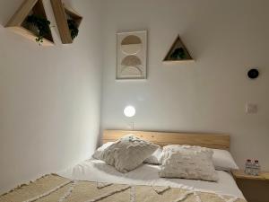 a bedroom with a bed with two pillows on it at Niña Mala in Valencia