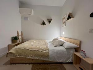 a bedroom with a bed with white walls at Niña Mala in Valencia