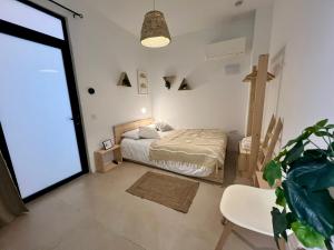a bedroom with a bed and a large window at Niña Mala in Valencia