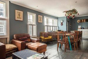 a living room filled with furniture and a dining room at The Old Post Office - Truly unique, quirky house in Kent