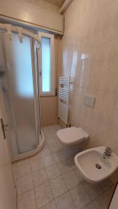 a bathroom with a shower and a toilet and a sink at Verbena Holiday Apartment in Lazise
