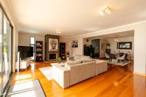 a living room with a couch and a table at Villa Nunes, Big Holiday house with private pool in Calheta