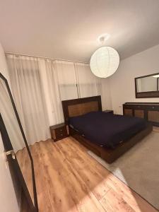a bedroom with a bed and a chandelier at Apartament Anca in Sibiu