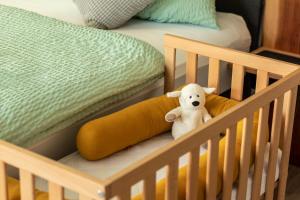 a stuffed teddy bear is sitting in a crib at Rhön & Relax in Wildflecken