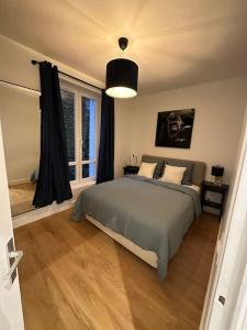 - une chambre avec un lit et une grande fenêtre dans l'établissement Paris Auteuil/Rolland Garros, à Boulogne-Billancourt