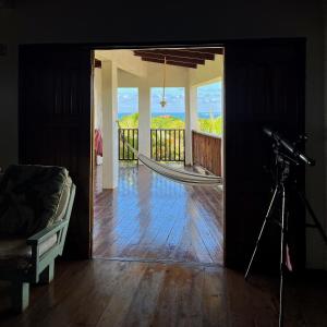 a camera on a tripod in a room with a hammock at Da Fabio in Negril