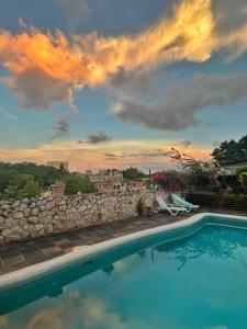 a swimming pool with a sunset in the background at Da Fabio in Negril