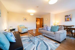 a living room with a couch and a table at Central Dingle Stay in Dingle