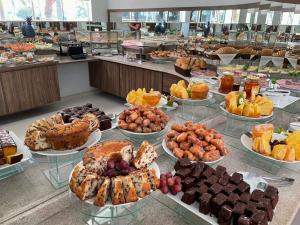 a buffet filled with lots of different types of food at Hotel Jardim in Jardim
