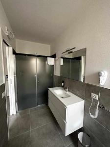a bathroom with a sink and a shower and a mirror at La Residenza del Re! in Palau +20 photos