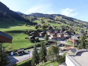 a village on a green hill with houses at Duplex cosy et spacieux avec piscine et balcon proche des pistes pour 4-5 personnes à Arêches-Beaufort - FR-1-342-171 in Arêches +4 photos