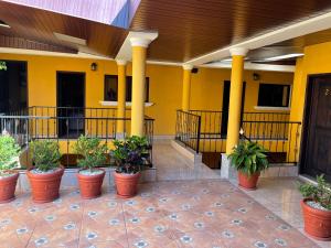 a lobby with potted plants inront of a building at Casa Alegria in Cobán