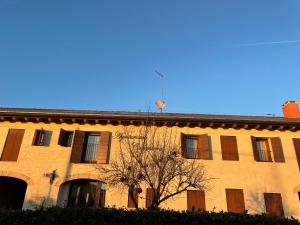 a building with a tree in front of it at Agriturismo Colombera in Quarto dʼAltino