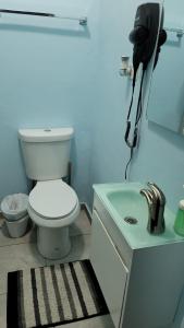 a bathroom with a toilet and a sink and a phone at Spacious 2 BR, fully equipped kitchen close to Ferry, Unit 5 in Catano