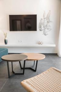 a living room with a table and a tv at Villa Aphrodite - Ionian Treasure Villas in Kefallonia +35 photos