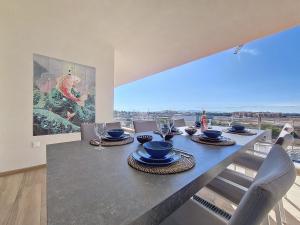 a dining room with a table with chairs and a large window at Los Alcazares Velapi - 0510 in San Javier