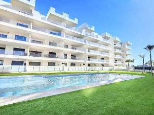 a large apartment building with a swimming pool in front of it at Los Alcazares Velapi - 0510 in San Javier