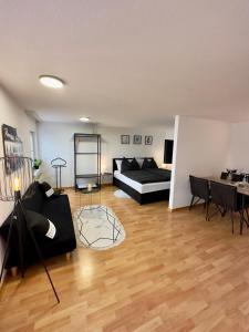 a living room with a couch and a table at Charmante Wohnung am Hafen in Bregenz