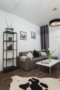 a living room with a couch and a table at Апартаменти біля Оперного Театру in Lviv
