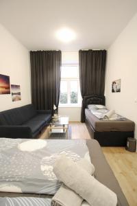 a living room with two beds and a couch at Comfort Apartment HG in Vienna