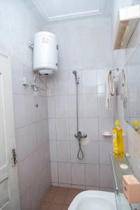 uma casa de banho com um chuveiro, um WC e um lavatório. em Studio cosy et moderne em Lomé