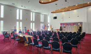 a large room with chairs and tables and a stage at Kompleksi CFN ALBANIA in Pogradec