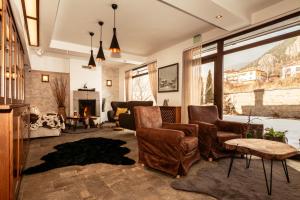 a living room with chairs and a fireplace at Hotel Smilen in Smolyan