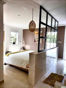 a bedroom with a large bed and a large mirror at Villa targa in Mirleft
