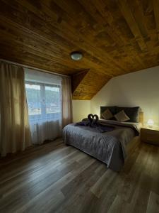 a bedroom with a bed and a large window at Chata Fir in Martin
