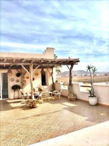 a porch of a house with chairs and a patio at Villa targa in Mirleft