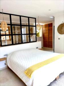 a bedroom with a white bed with a large window at Villa targa in Mirleft +37 photos