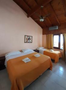 a bedroom with two beds with towels on them at San Remo Viking Hotel in Pinamar