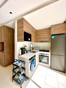 a kitchen with a washer and a dishwasher at L'Amina - Peaceful 1BR Retreat with Cold Jacuzzi in Tangier