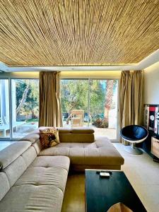 a living room with a couch and a large window at L'Amina - Peaceful 1BR Retreat with Cold Jacuzzi in Tangier
