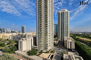 a tall building in a city with tall buildings at Luxury 3 Bed Apt with Golf Views in the Greens in Dubai