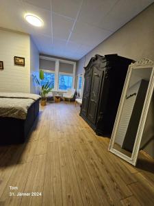 a bedroom with a dresser and a mirror on the floor at Gästhus Nornäs in Nornäs