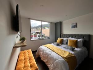 a bedroom with a large bed and a window at Confort 401 Apartamento Duitama in Duitama