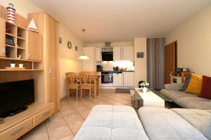 Una sala de estar con un sofá y un comedor. en Altes Wasserwerk App 09, en Wustrow