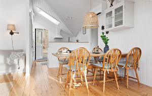 a kitchen and dining room with a table and chairs at 3 Bedroom Stunning Home In Hornbæk in Hornbæk