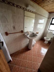 a bathroom with a sink and a toilet at Doolin Getaway. in Lisdoonvarna