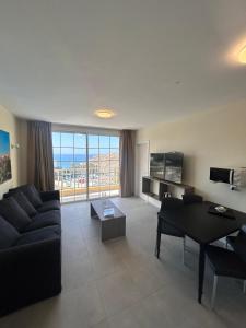 a living room with a couch and a table at Villa del Mar in Patalavaca