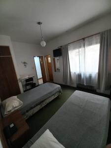Postel nebo postele na pokoji v ubytování Residencial Ski