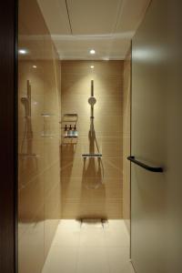a bathroom with a shower with a glass door at Candeo Hotels Osaka Shinsaibashi in Osaka