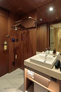 a bathroom with a sink and a shower at Candeo Hotels Osaka Shinsaibashi in Osaka