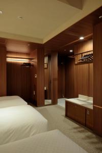 a hotel room with a bed and a bathroom at Candeo Hotels Osaka Shinsaibashi in Osaka