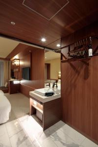 a bathroom with a sink in a room at Candeo Hotels Osaka Shinsaibashi in Osaka