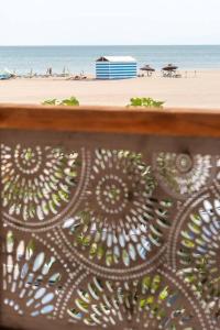 a metal fence with a beach in the background at La Javanaise in Narbonne-Plage