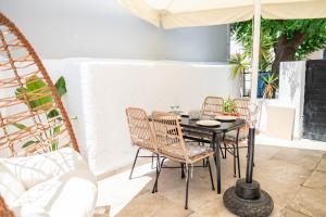 a patio with a table and chairs and an umbrella at Kosnian City Suites B in Kos Town