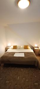 a bedroom with a large bed with two night stands at Apartmány Grobarčík in Zuberec